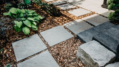 Gray pavers, wood chips, dark blocks. Photo