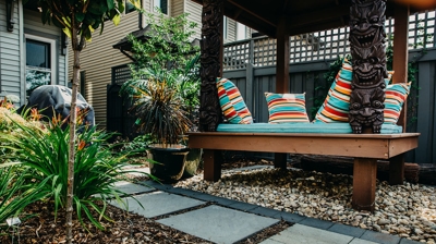 Patio with colorful bench, gardens, and pathways. Photo